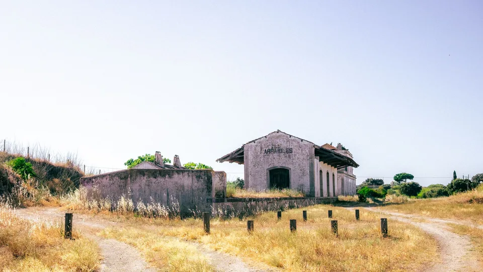 An abandoned rural railway station at Arraiolos, Alentejo, in dry summer grass