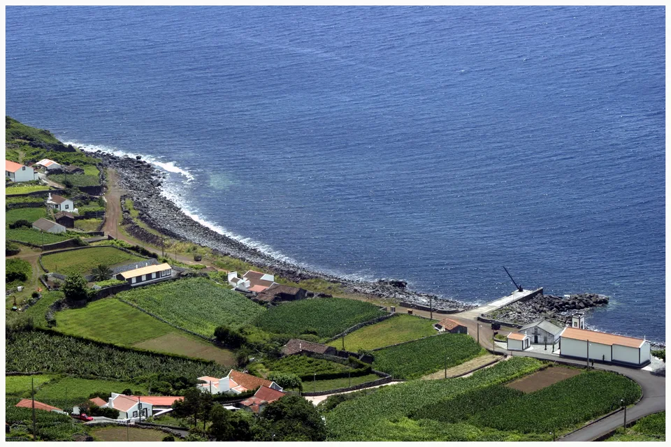 Fajã dos Vimes on the south coast of São Jorge, Azores — houses and fields on the shelf of land under the cliff